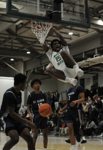 SLAM DUNK - Senior JJ Massaquoi dunks during the varsity boys' basketball home opening vs. St. Albans.